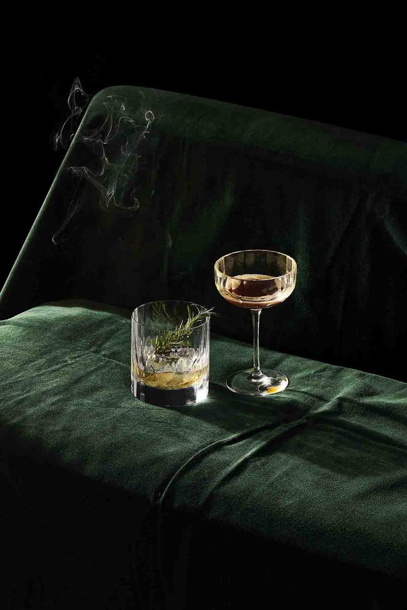 picture of a glass of spirit with a smoking cigarette which is a trigger for rosacea