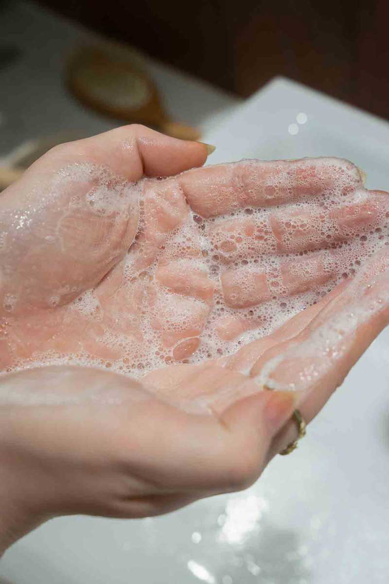 picture of hands with cleanser for rosacea prone skin