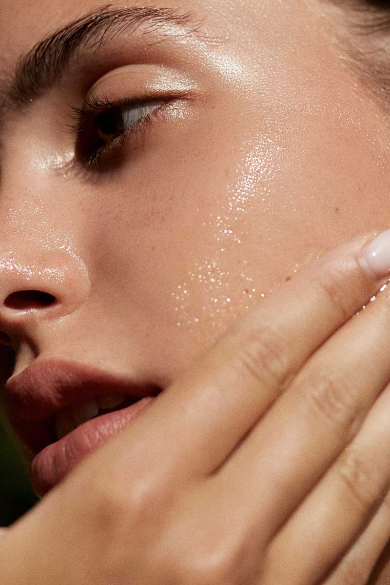 picture of a woman applying a skincare routine for rosacea