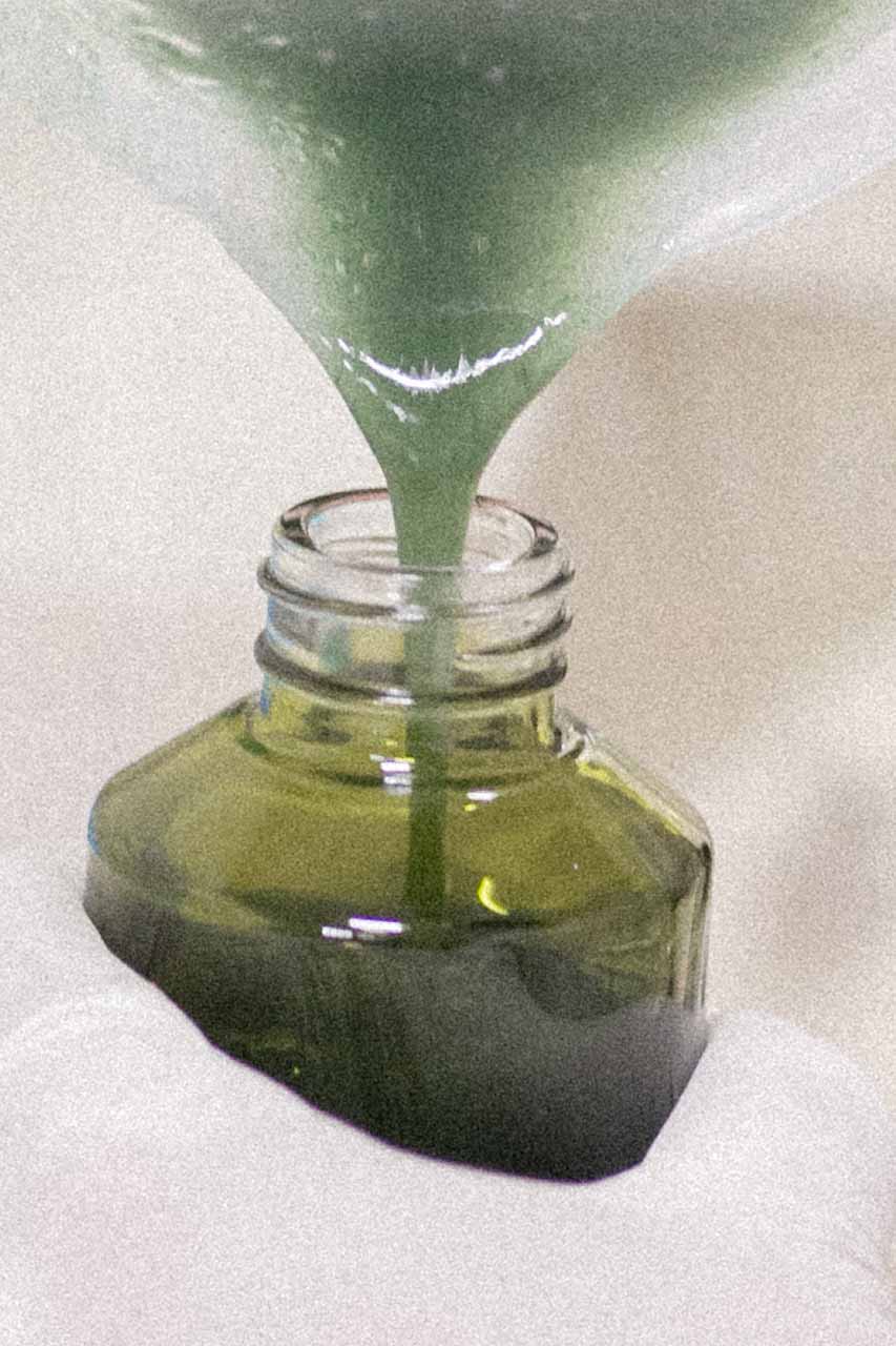 image of a freshly mixed organic skincare compound being poured in Fields of Yarrow sustainable packaging