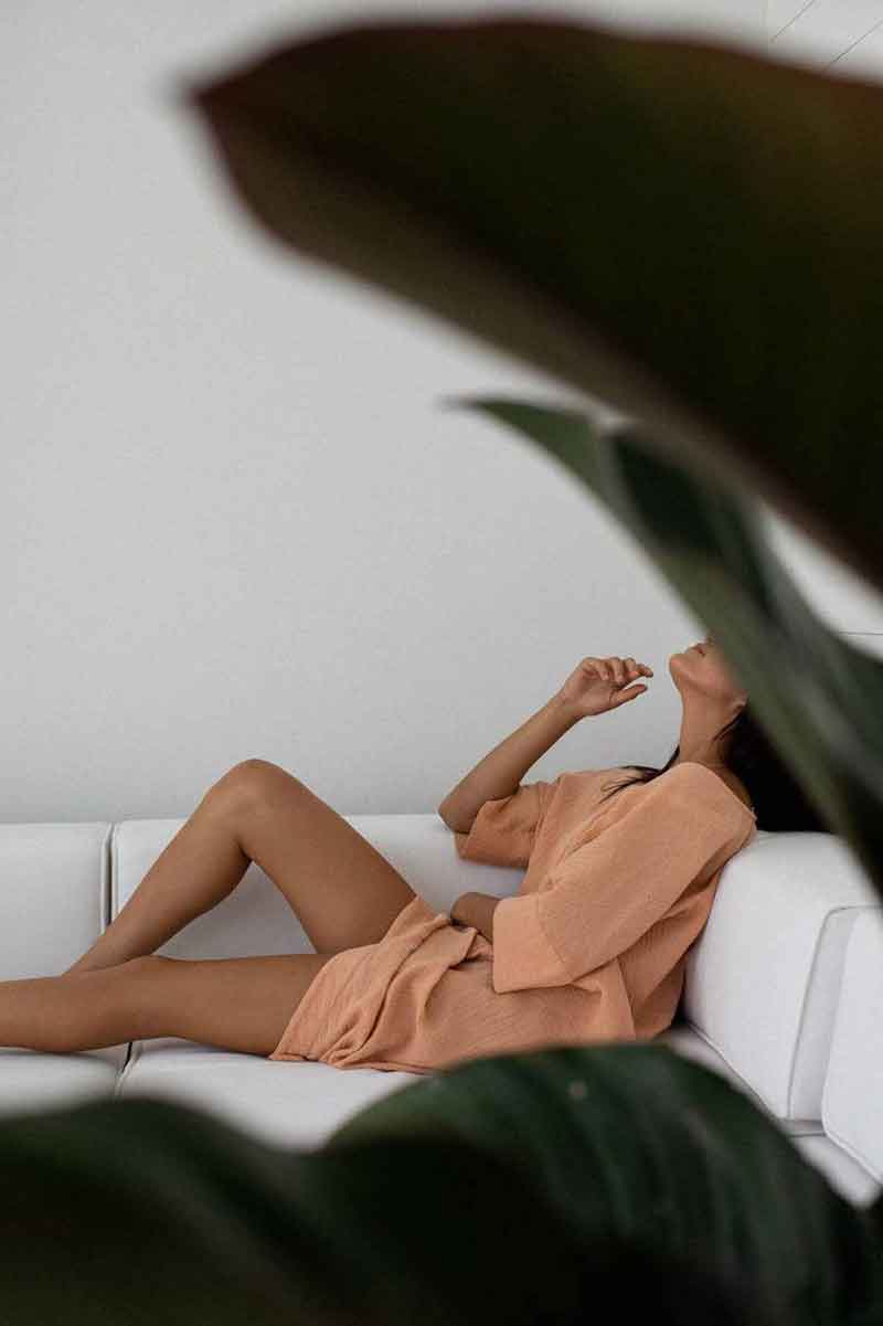 picture showing a woman relaxing in her house on the sofa