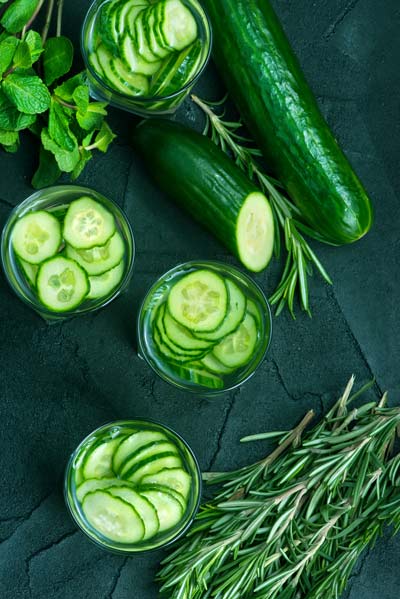 image from above of cut cucumber superfood on a dark surface