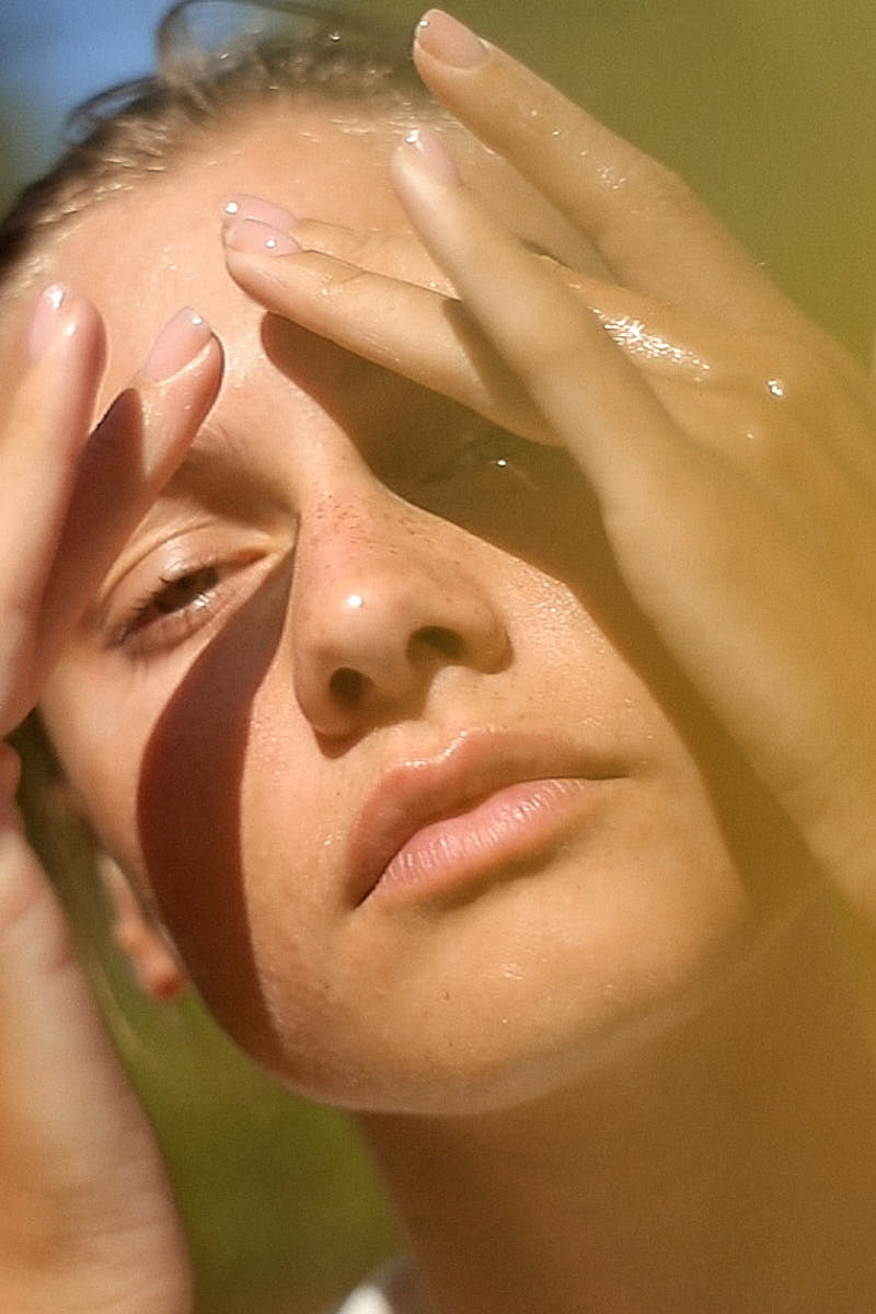 image of a young woman using the nectar de rose oil to milk in her anti aging skincare routine