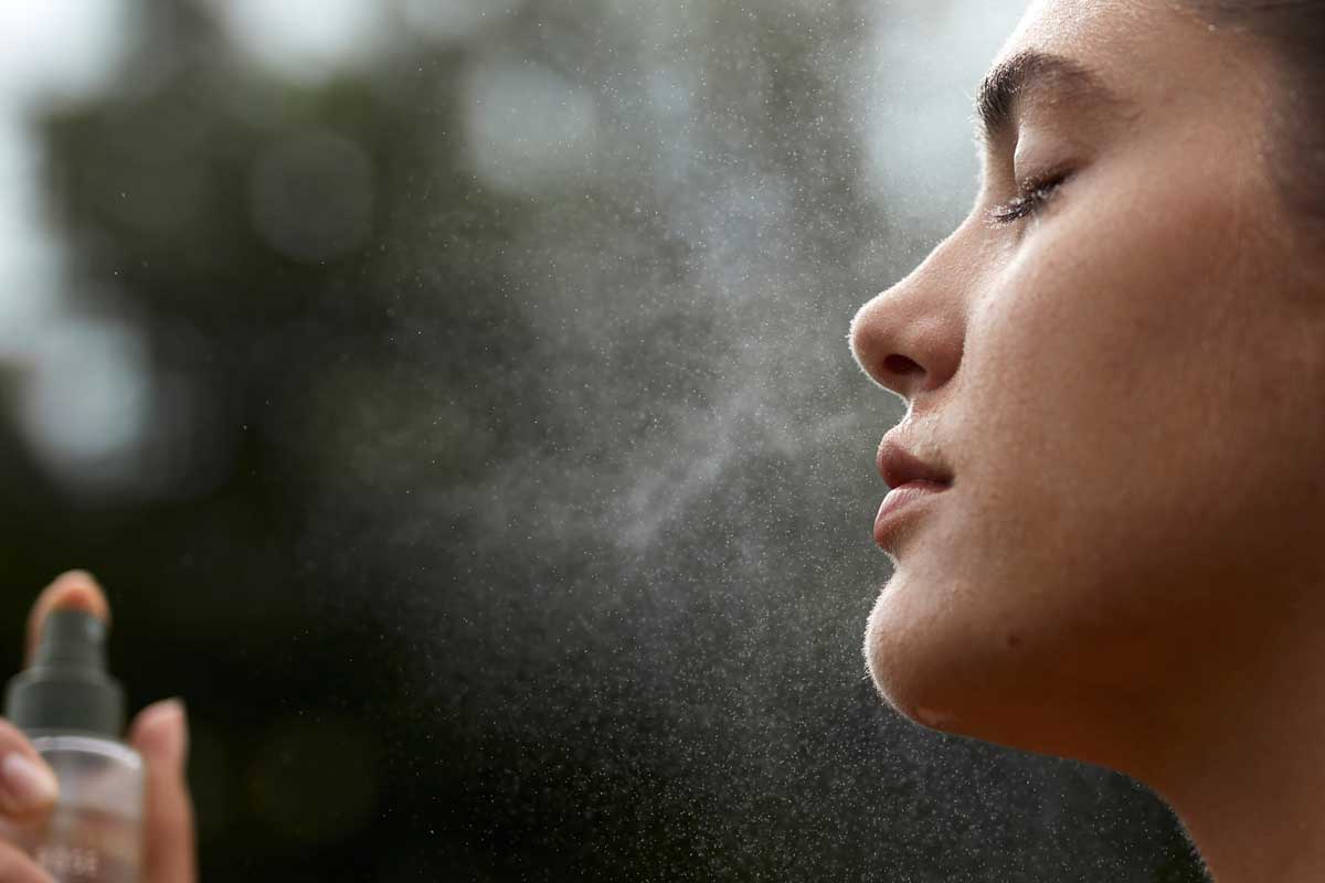 image of a girl spraying bulgarian rose water in her anti-aging skincare routine