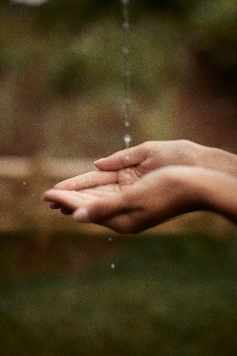 picture of a woman's hand catching water to cleanse her face during a skincare routine