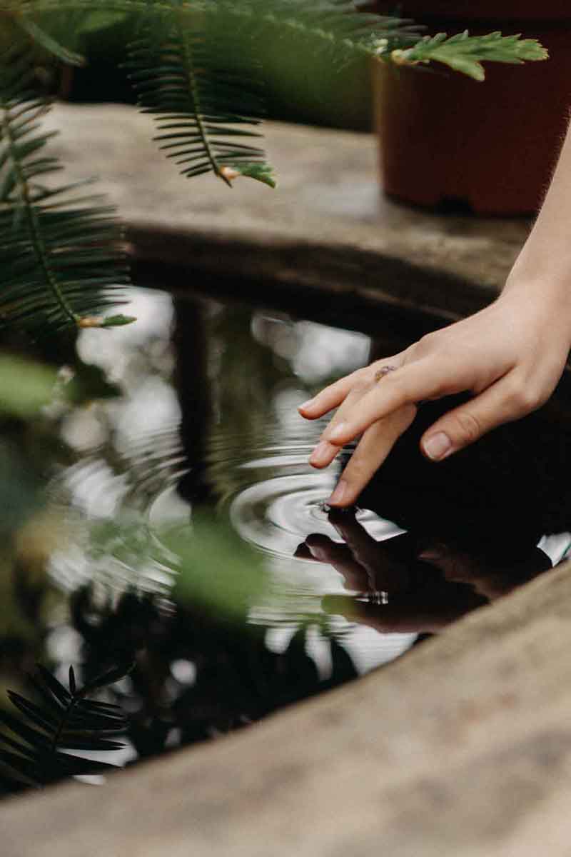 image of a girl gently touching the surface of a clean water well