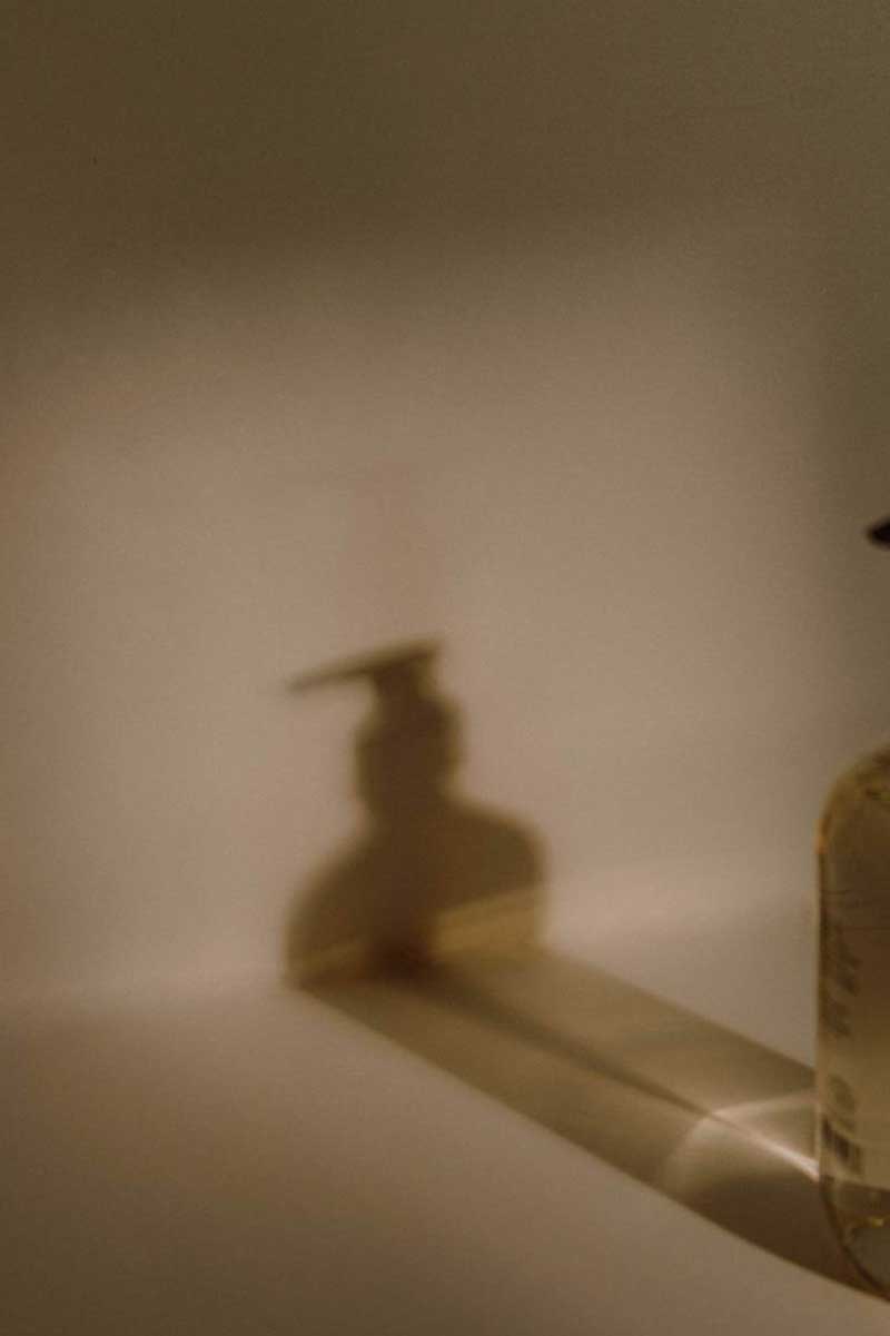 decorative image of the shadow of a bottle of body oil