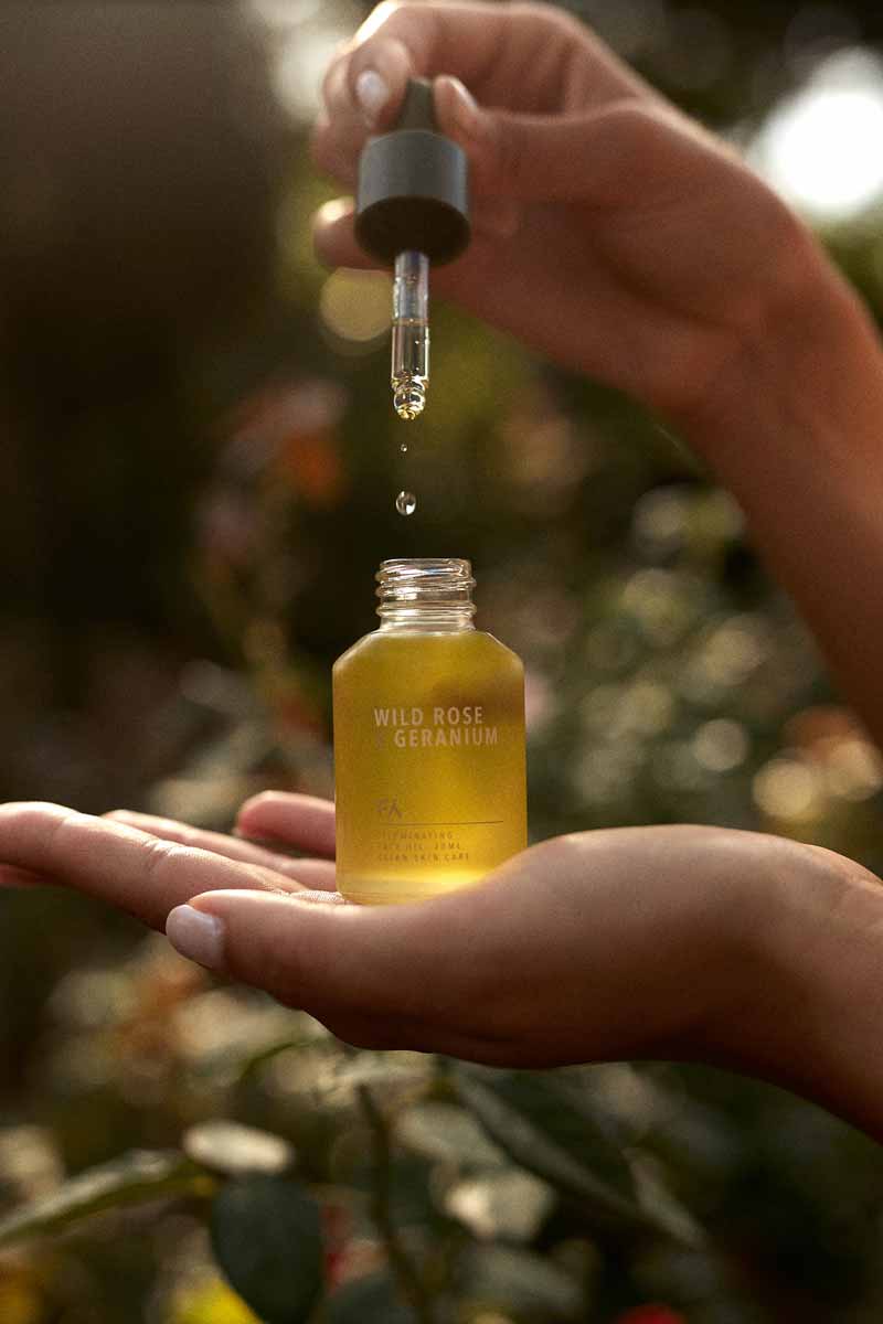 facial oil by fields of yarrow being used in the nature