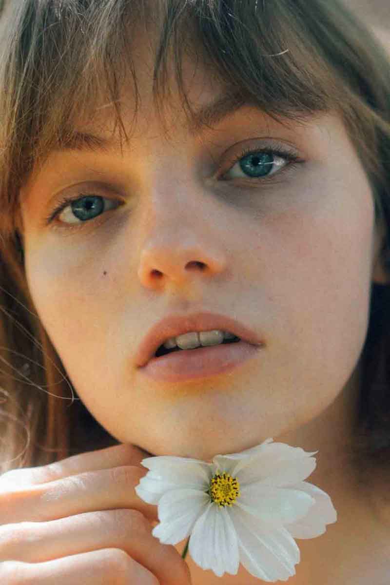 picture of a girl with a flower useful for her dry skin