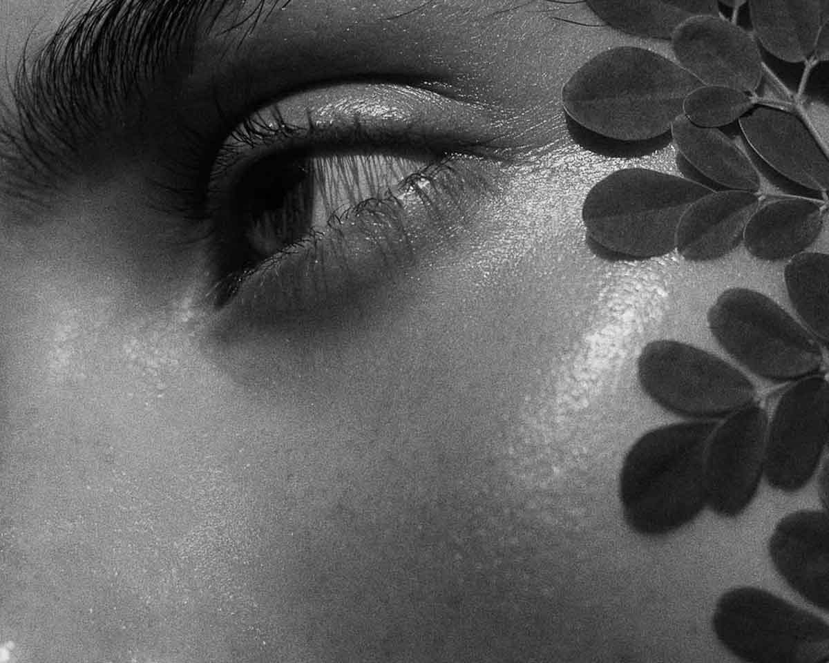 cover image for the article the nighttime skincare routine for acne prone skin showing the eye of a young woman in black and white