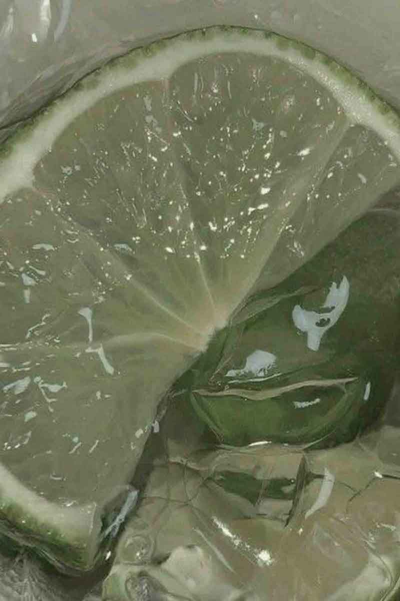 close up on a lime during the lime essential oil extraction process<br />
