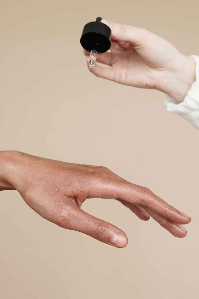 image of a person testing products for fine lines on their skin