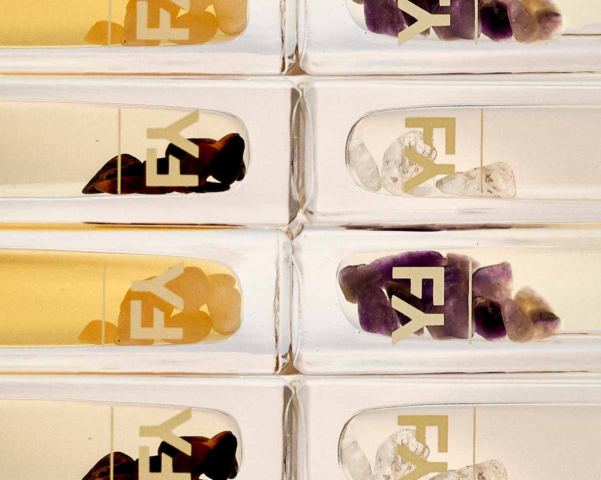 Cover image for the article How Minerals Help Combat Acne showing fields of yarrow perfume oils with minerals