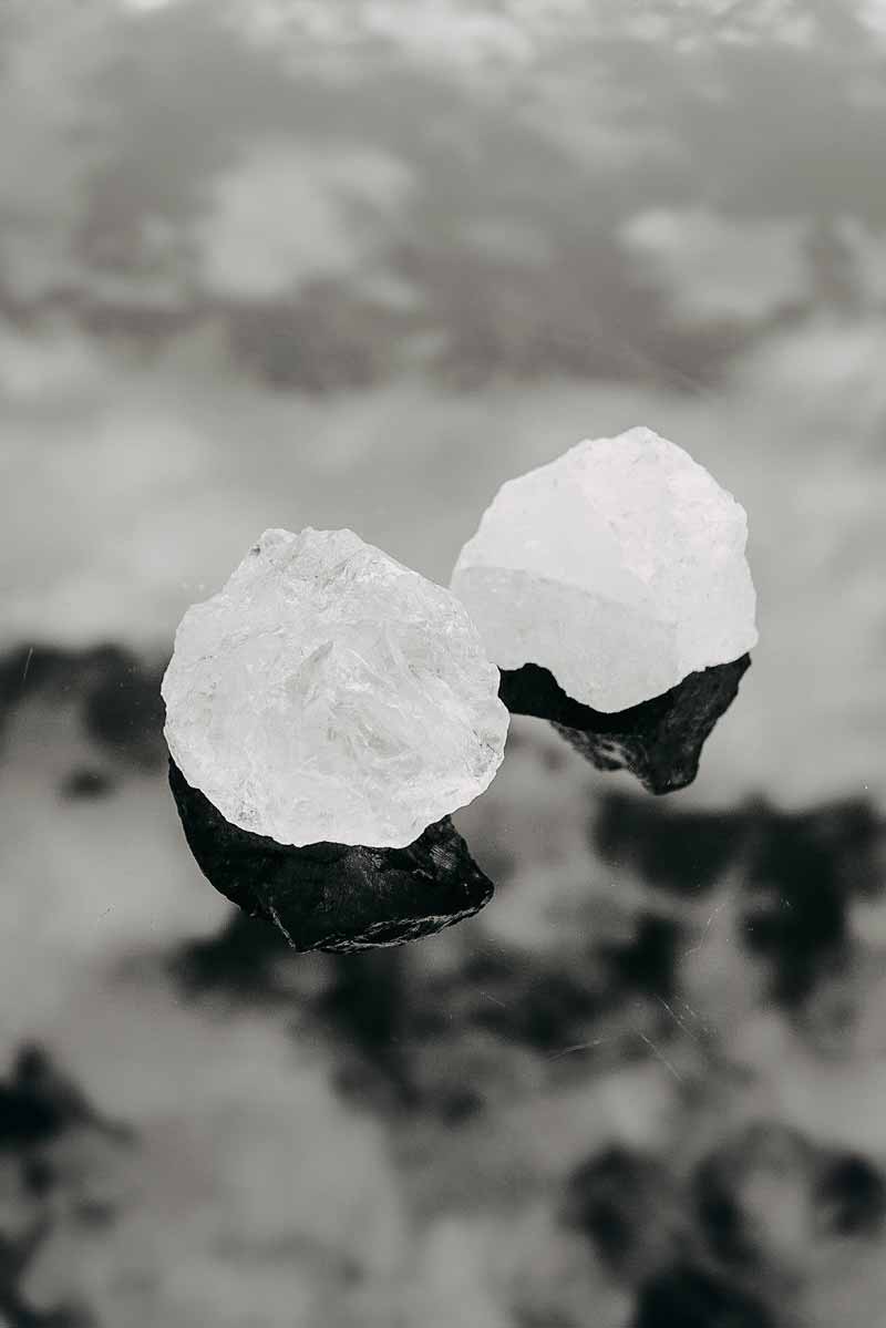 close up picture of minerals used against acne on a reflective dark surface
