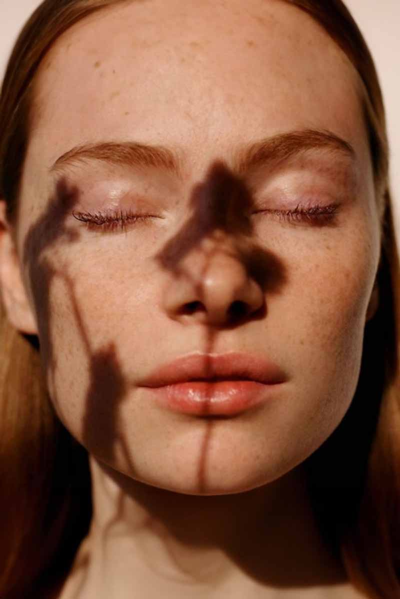 Decorative picture of a beautiful young woman with freckles